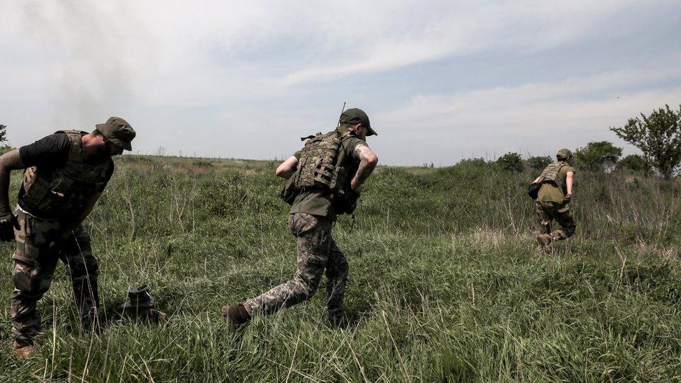 Ukrainian servicemen from the 24th Mechanized Brigade "King Danylo" leave their position after firing a BM-21 "Grad" multiple rocket launcher system (MLRS) in the direction of the frontline city of Bakhmut, at an undisclosed location, Donetsk region, eastern Ukraine, 19 May 2023