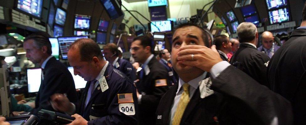 A trader works on the floor of the New York Stock Exchange September 15, 2008