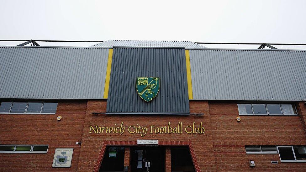 Exterior shot of Norwich City stadium Carrow Road showing name and logo of club