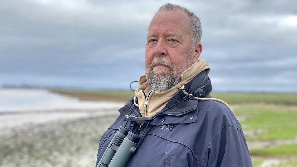 Birdwatcher Paul Bowerman standing on the banks of the River Severn near Bristol