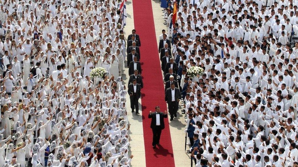 Followers cheer Naáson Joaquín García as he walks down a red carpet