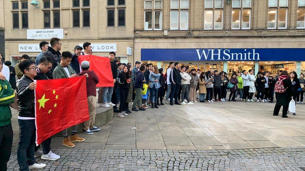 Protesters holding Chinese flags