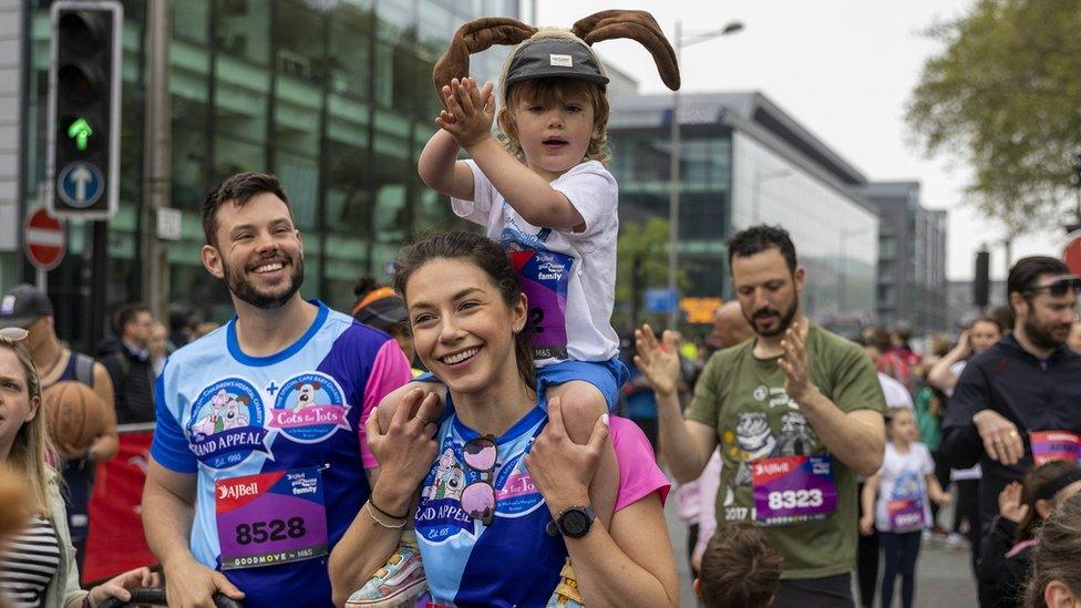 Young boy on the shoulders of a female runner who had taken part in the Great Bristol Run