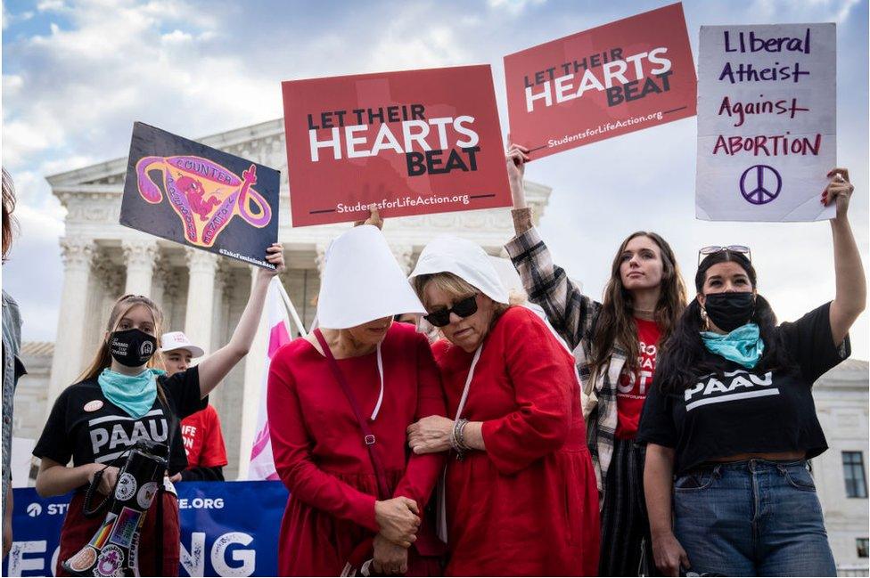 Protesters on both sides held rallies outside the court on Monday