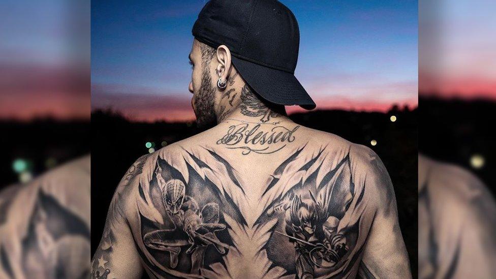 Footballer Neymar displaying a back tattoo of Spiderman and Batman