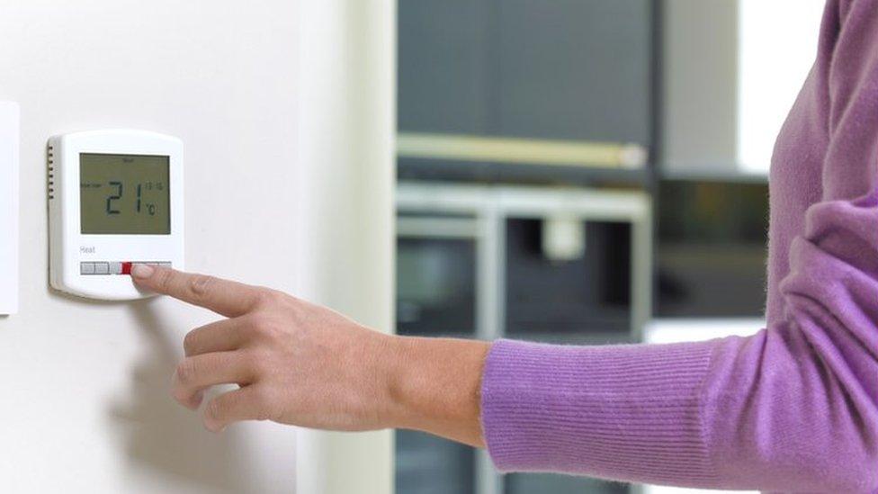 Woman turning on her heating