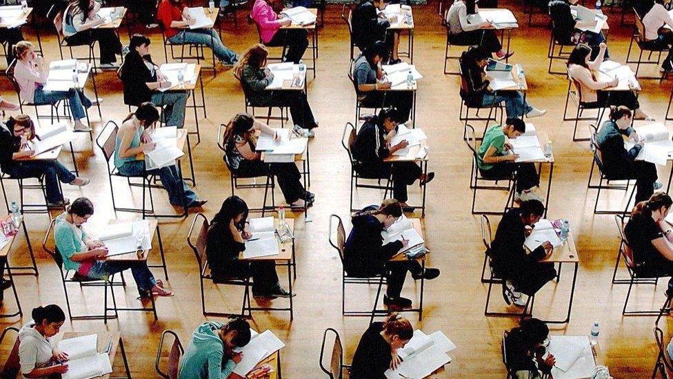 Pupils at desks in exam room