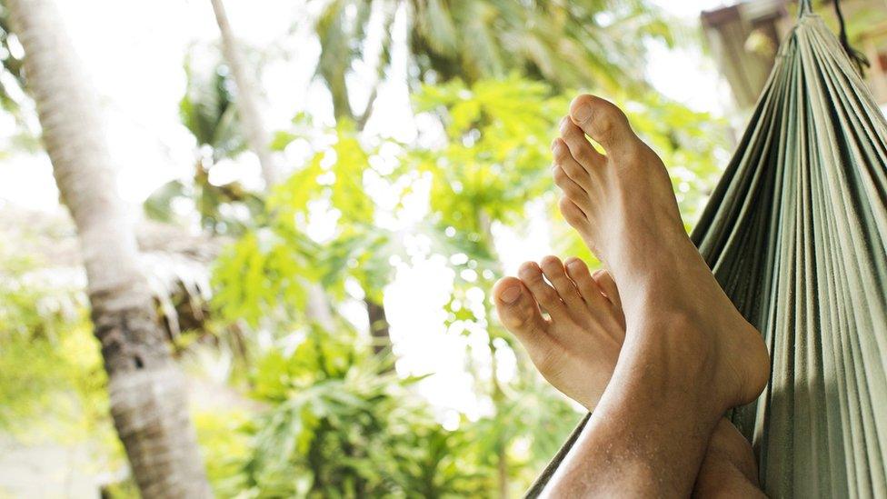 Feet relaxing on a hammock