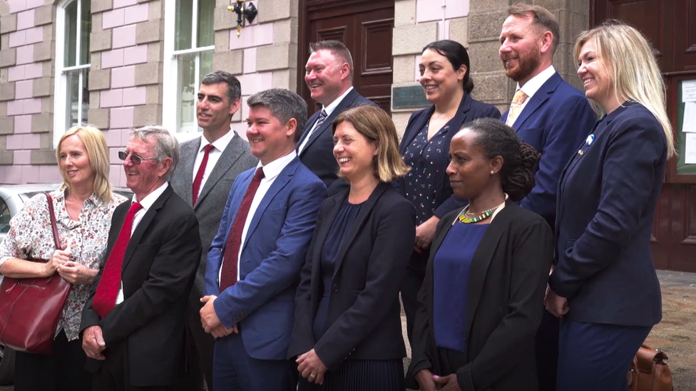 Members of Reform Jersey outside government building