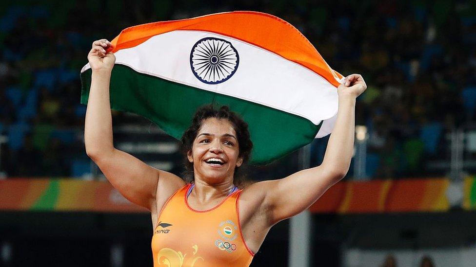 India's Sakshi Malik celebrates after winning against Kirghyzstan's Aisuluu Tynybekova in their women's 58kg freestyle bronze medal match on August 17, 2016