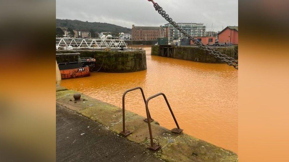 Orange coloured water in Whitehaven Harbour