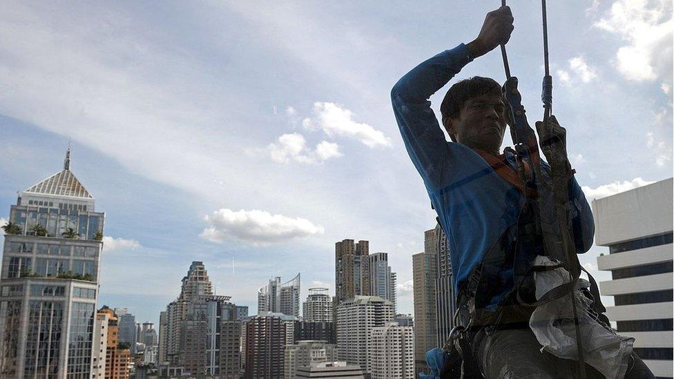 Man window cleaning in Bangok