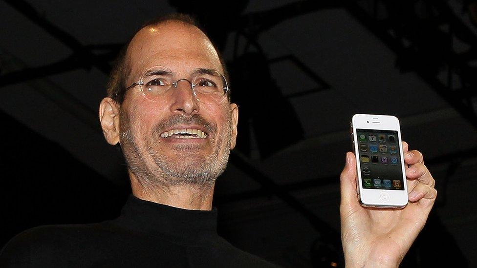 The late Apple boss Steve Jobs pictured with the fourth generation Iphone