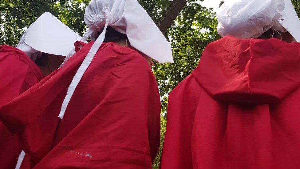 protesters dressed as handmaids during anti-Trump protests in London