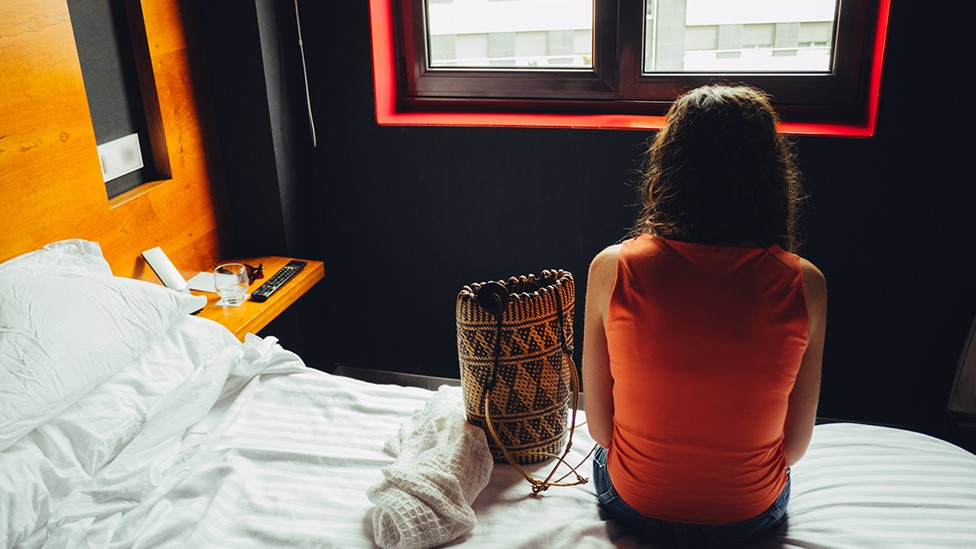 A woman in a hotel room