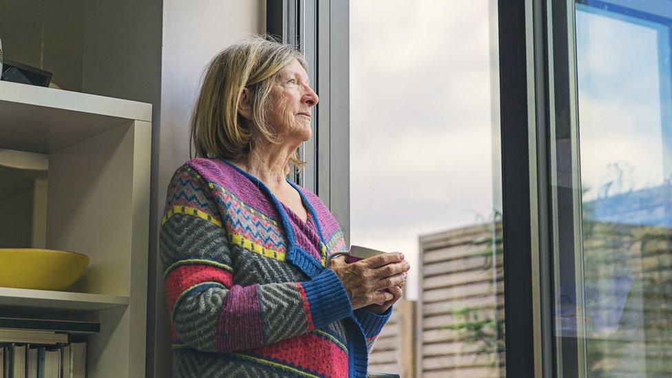 Woman looking out of window