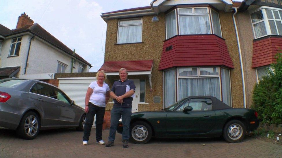 Veronica and Phil Rumsey in front of their house