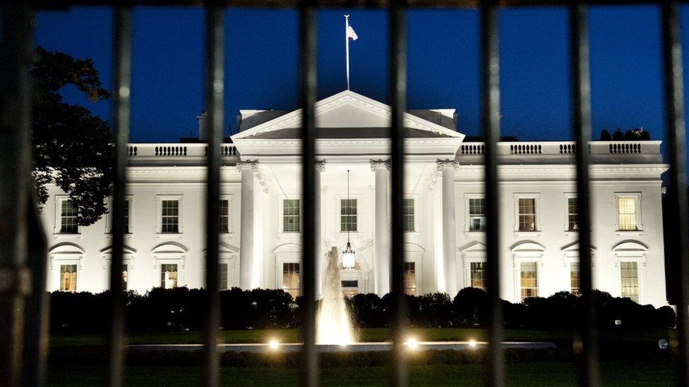 The White House is seen at dusk on the eve of a possible government shutdown as Congress battles out the budget in Washington, DC, September 30, 2013.