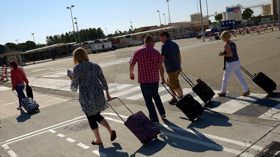 People pulling suitcases