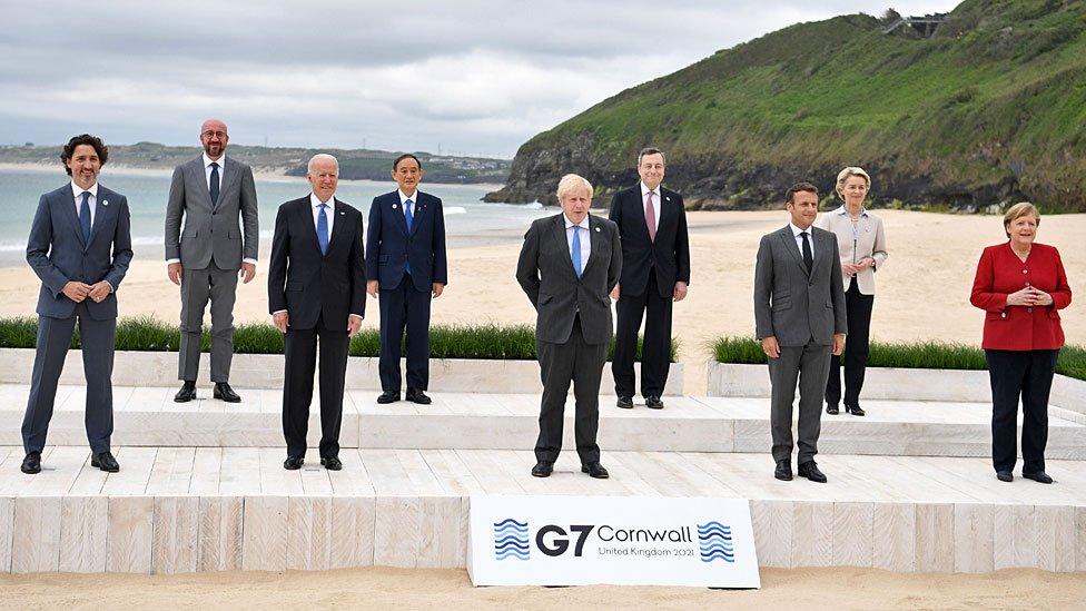 Nine world leaders gather on the beach in Carbis Bay for a photograph together