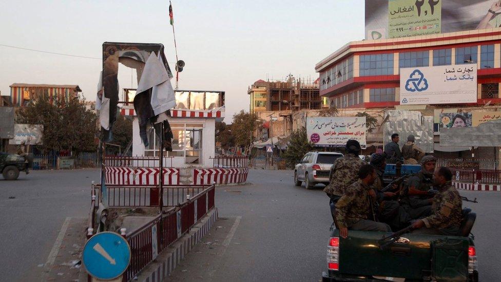 Afghan security forces make their way through a part of Kunduz on 1 October 2015