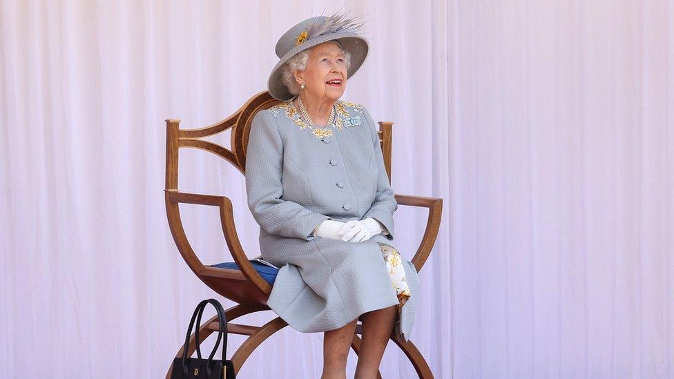 Queen Elizabeth II watches the Red Arrows fly over during a ceremony at Windsor Castle in Berkshire to mark her official birthday. Picture date: Saturday June 12, 2021