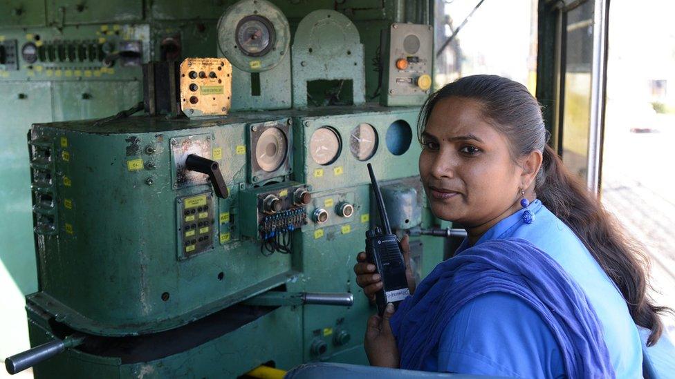 Indian Railways locomotive driver Lakshmi Devi talks on a radio inside a train at a railway station in Secunderabad, India, 2015.