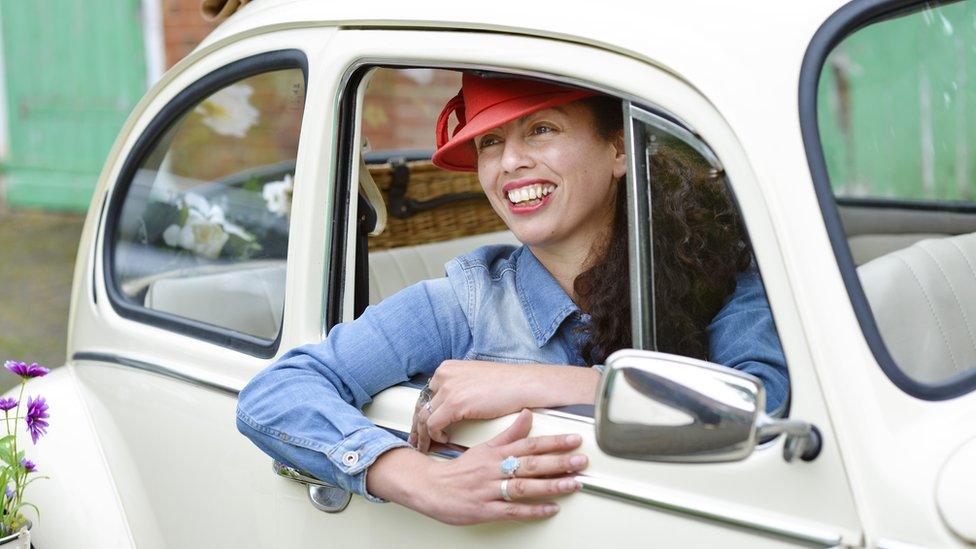 Nathalie Selvon-Bruce sitting in a VW bug