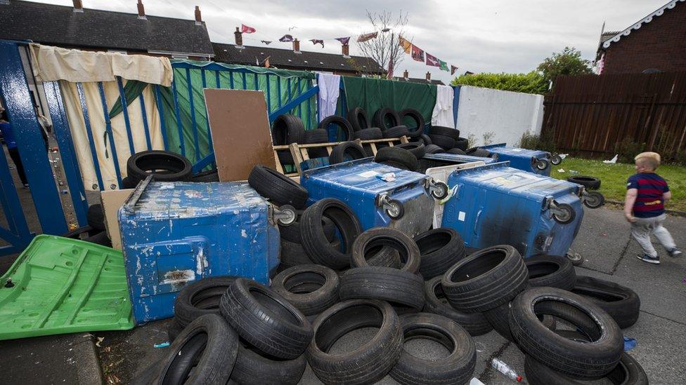 Tyres, bins and wood block the gate at Avoniel Leisure Centre