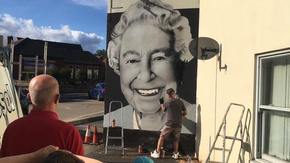 Mr Gaden working on the mural