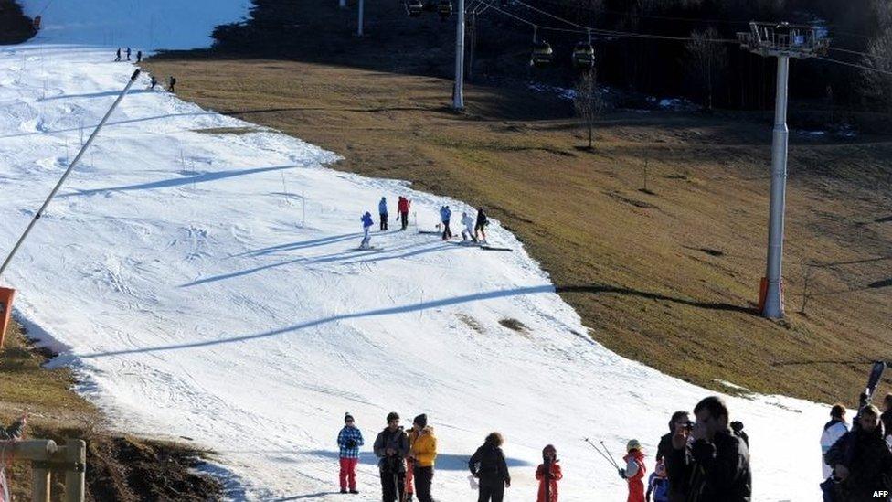 Skiers on a thin layer of snow in Villard-de-Lans, central-eastern France 27/12/2015