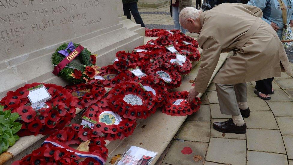 A veteran places a poppy wreath at the Cenotaph at Belfast City Hall