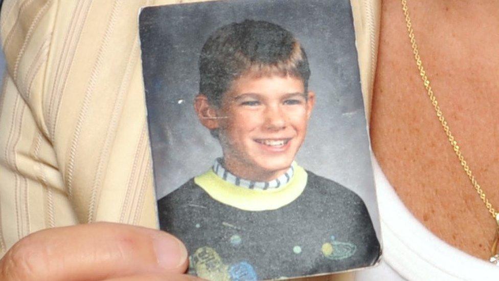 Patty and Jerry Wetterling hold up a picture of their son Jacob