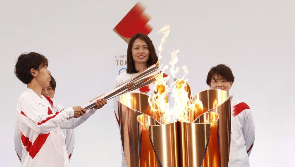 Azusa Iwashimizu lights the torch