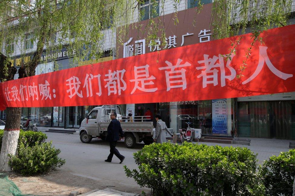 Banner saying "We are all residents of the capital" is seen in Xiongxian, Hebei province, China, 3 April 2017.