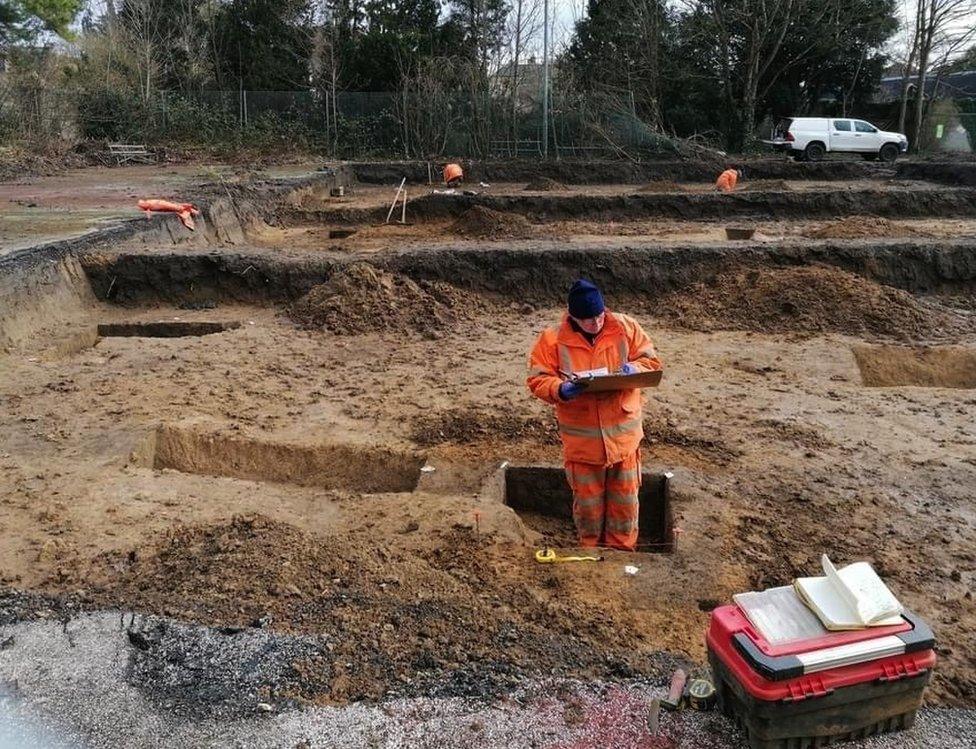 An archaeologist investigating the relationship between two phases of boundaries aligned with the boundary of St Michael’s Church