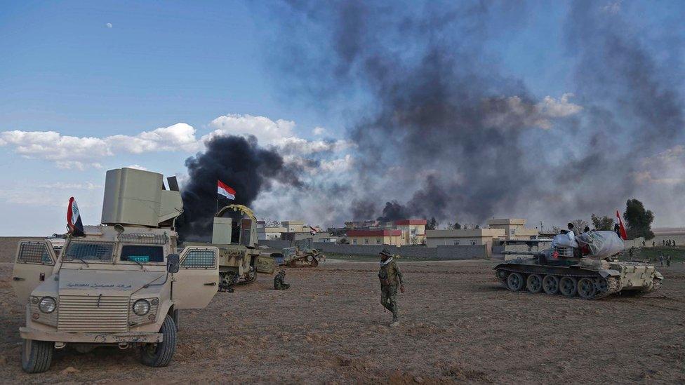 Iraqi government forces advance in the village of Badoush, some 15km northwest of Mosul, during the ongoing battle to retake the city's west from so-called Islamic State (IS), 8 March 2017