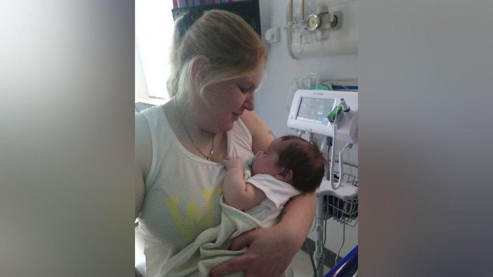 Laura Corkill holds her baby son