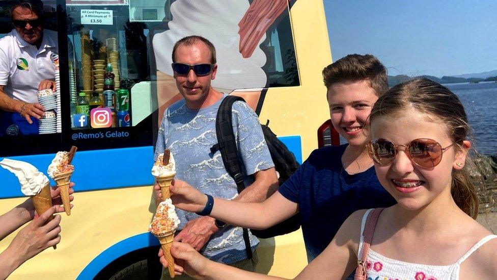 People eating ice creams to cool down at Loch Lomond