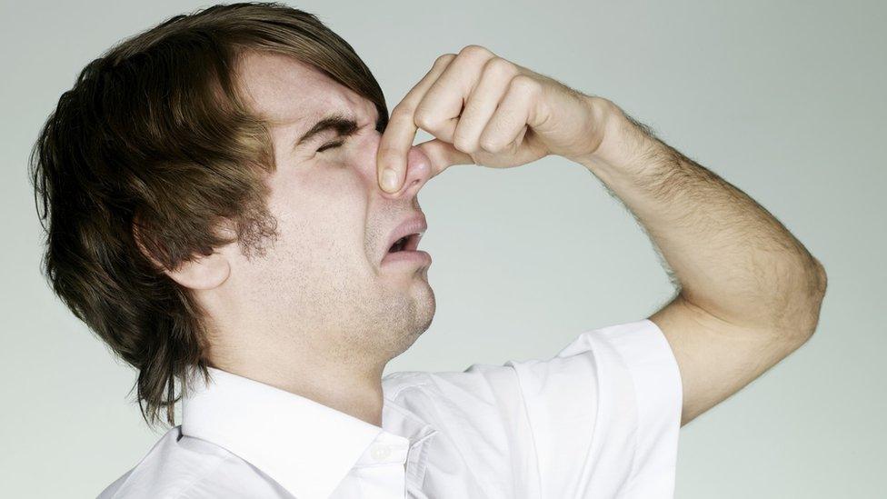 A man holding his nose