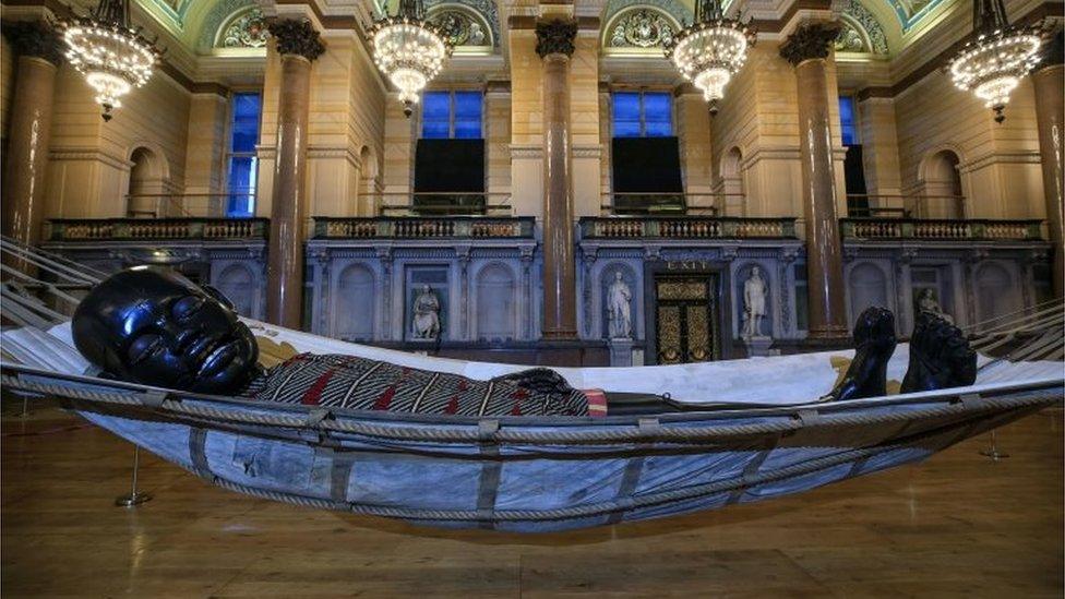 Little Boy Giant sleeping in a hammock