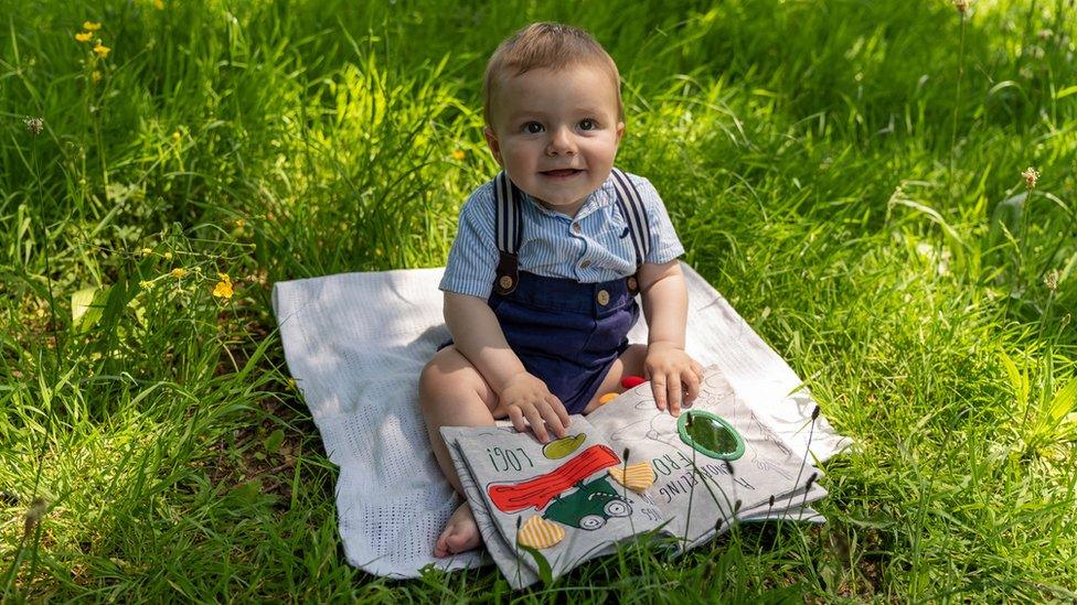 Branimir Foster sitting on a rug