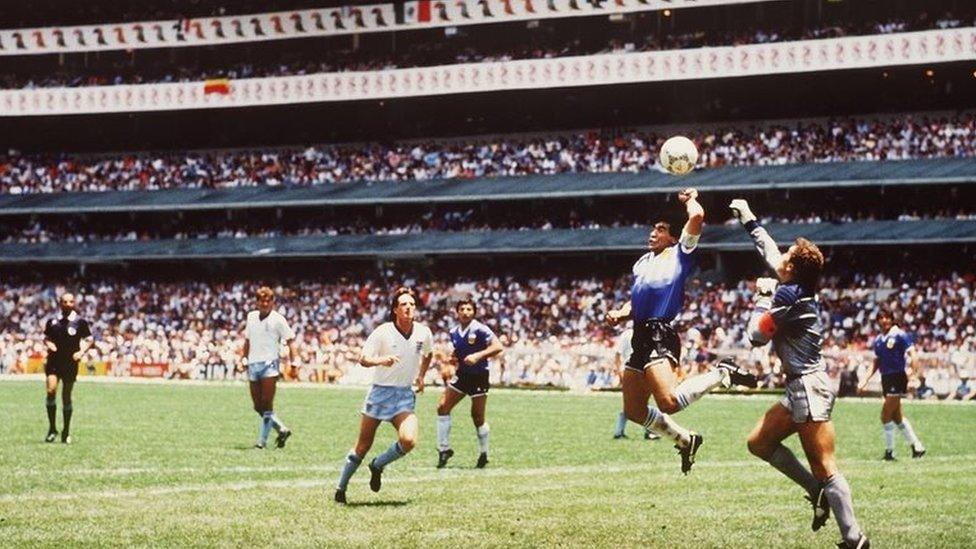 MEXICO 86, JUNE 22nd 1986 : FIFA World Cup Quarter Final, Azteca Stadium, Mexico: Argentina's Diego Maradona scores his side's first goal past English goalkeeper Peter Shilton by use of his hand, Maradona later claimed that the goal was scored by "The Hand Of God".