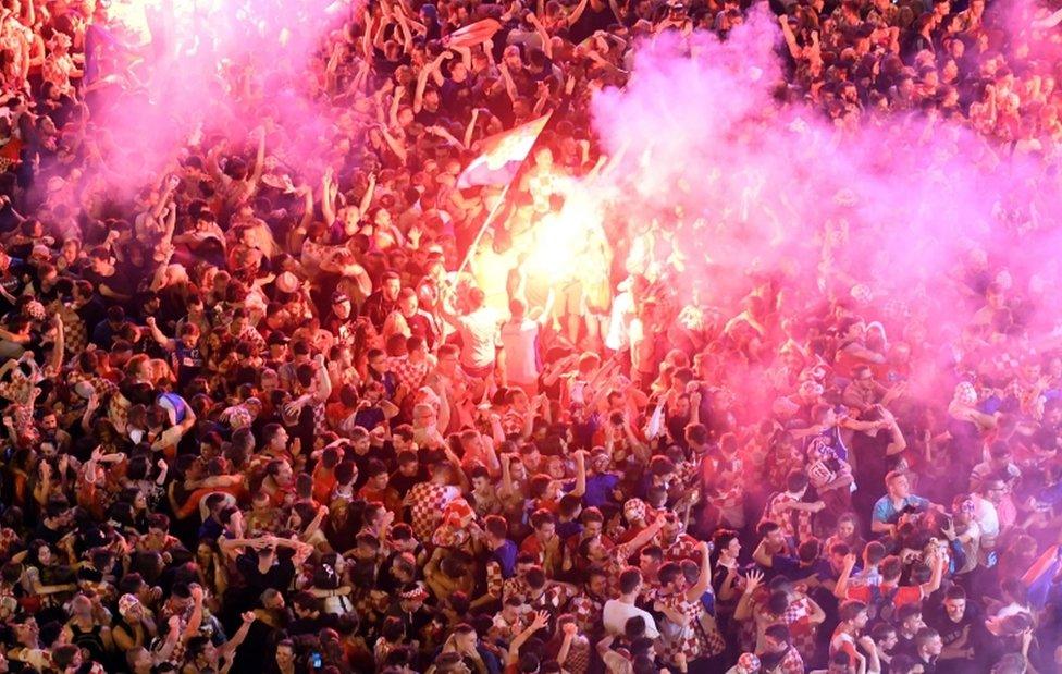 Croatia supporters celebrate the second goal as they watch on a giant screen the Russia 2018 World Cup semi-final football match between Croatia and England, at the main square in Zagreb