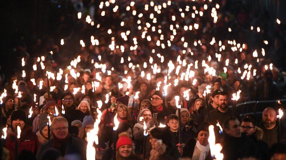 Members of of the public took part in a torchlight procession along the Royal Mile during Edinburgh Hogmanay celebrations