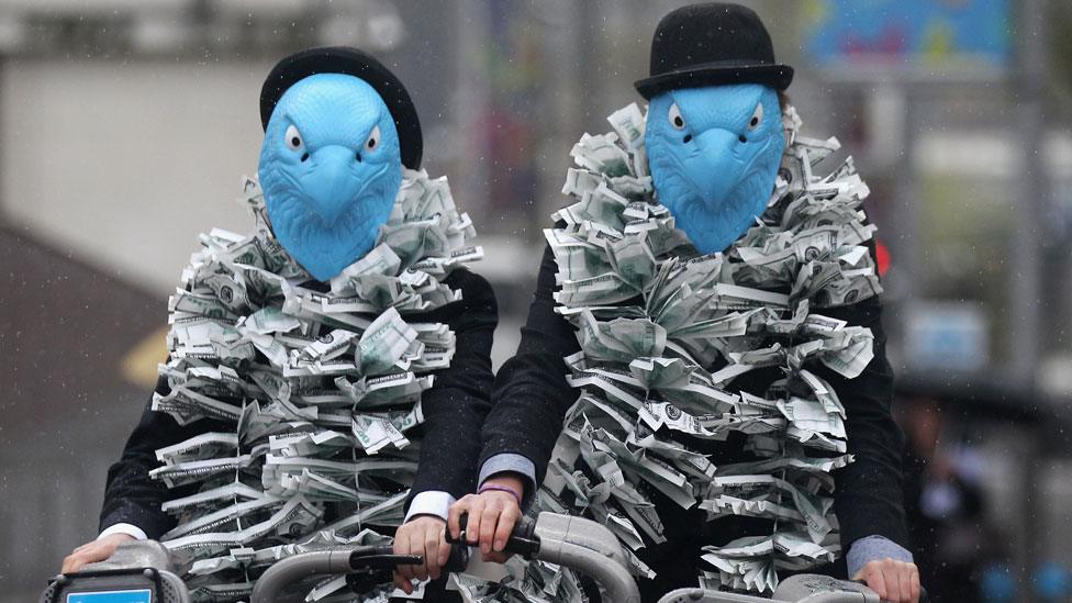 Protestors dressed as eagles protest against Barclays' pay arrangements at the company's 2012 AGM