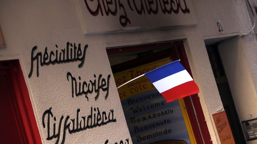 French flag hangs outside a restaurant in Nice, southern France