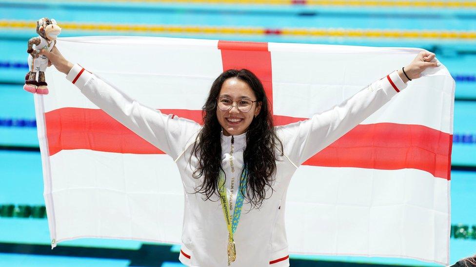 Alice Tai holds up flag.