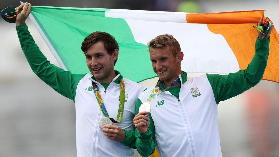 Gary and Paul O'Donovan celebrate with their silver medals