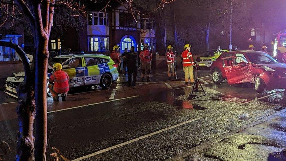 Crash between two cars including a police car